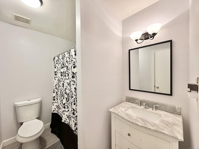 full bathroom with vanity, shower / bath combination with curtain, and toilet