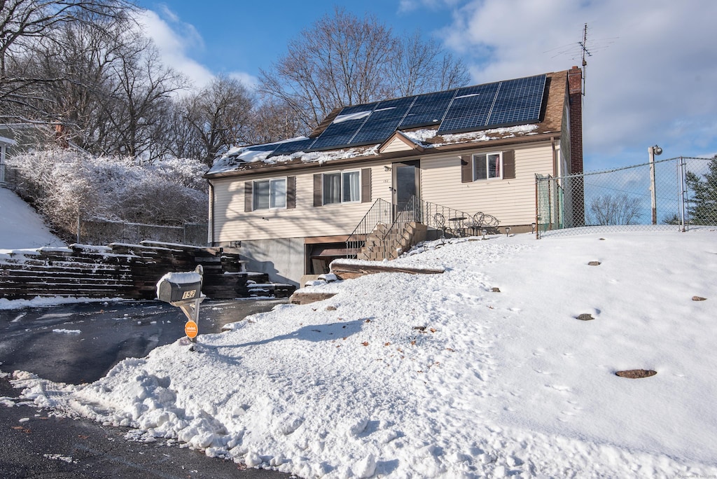 view of front of home featuring solar panels