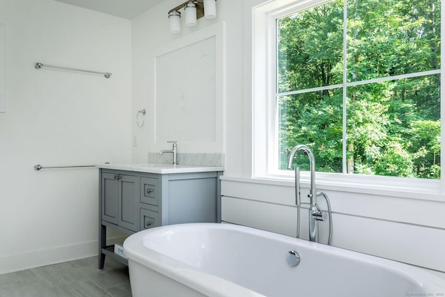 bathroom featuring vanity and a tub