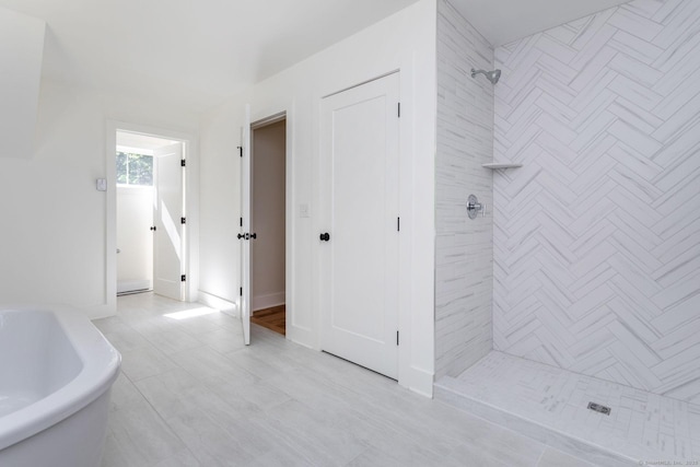 bathroom with tiled shower