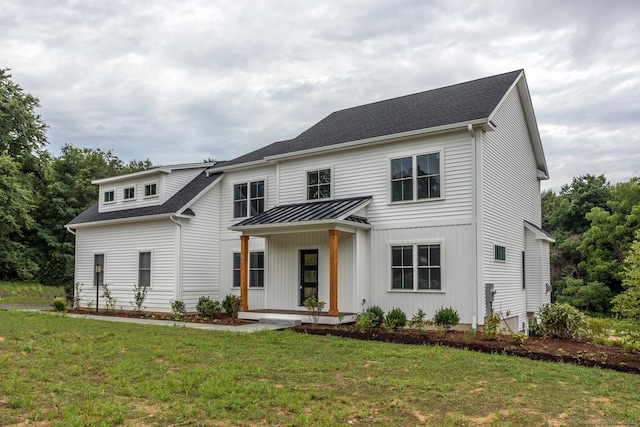 view of front of house featuring covered porch and a front lawn