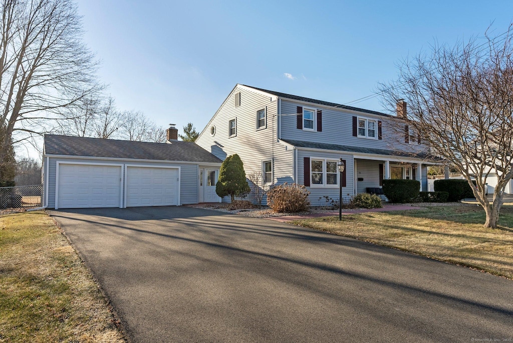 front facade featuring a front lawn and a garage