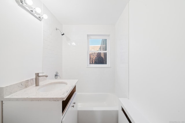 bathroom featuring vanity and tiled shower / bath