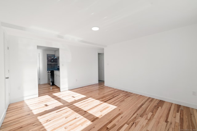 spare room featuring light wood-type flooring