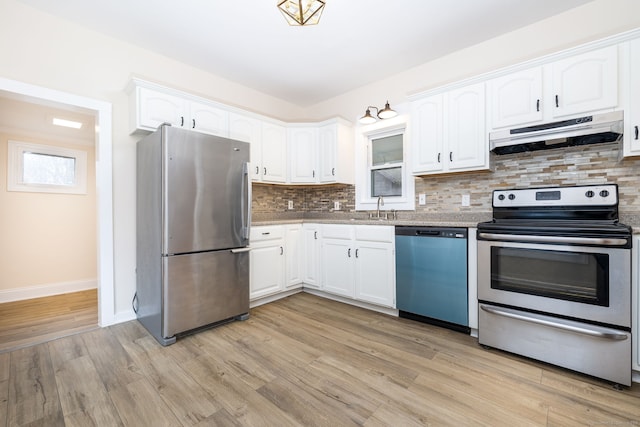 kitchen featuring white cabinets, light wood-type flooring, appliances with stainless steel finishes, and sink