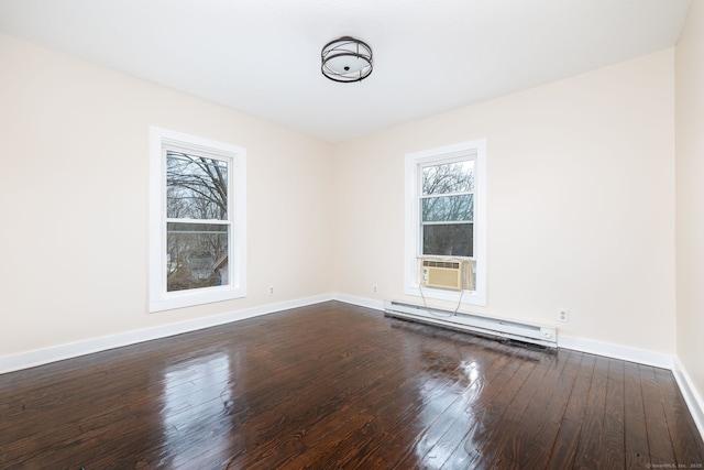 unfurnished room with a baseboard heating unit, dark wood-type flooring, and cooling unit