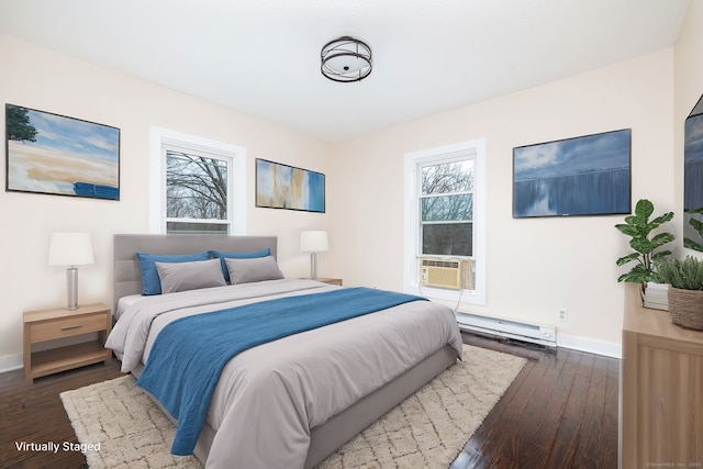 bedroom featuring cooling unit, a baseboard heating unit, and dark hardwood / wood-style floors