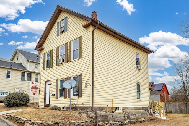 view of side of home featuring cooling unit