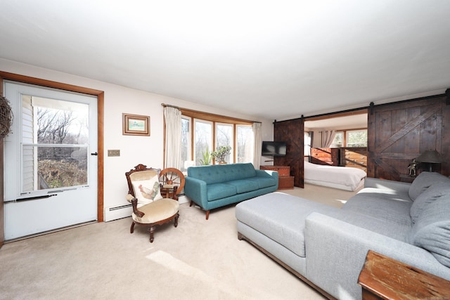 living room with carpet, a barn door, and a baseboard radiator