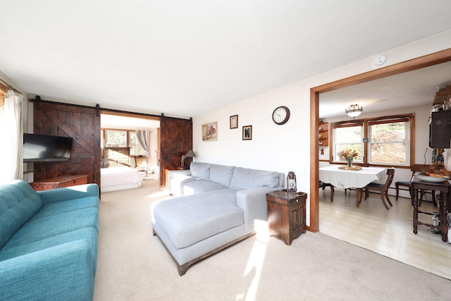 living room with light carpet and a barn door