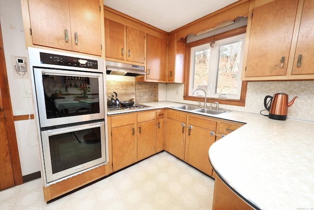 kitchen featuring decorative backsplash, sink, and appliances with stainless steel finishes