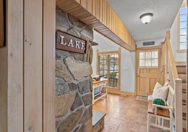 mudroom with a textured ceiling