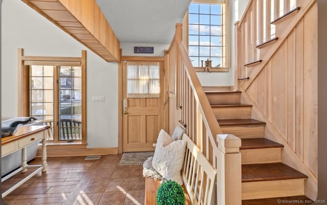 interior space with stairway, plenty of natural light, and visible vents