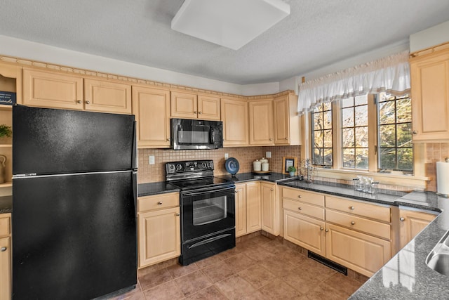 kitchen featuring tasteful backsplash, dark stone counters, black appliances, and light brown cabinetry