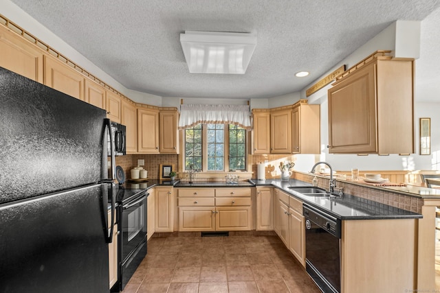 kitchen featuring light brown cabinets, a sink, backsplash, black appliances, and dark countertops