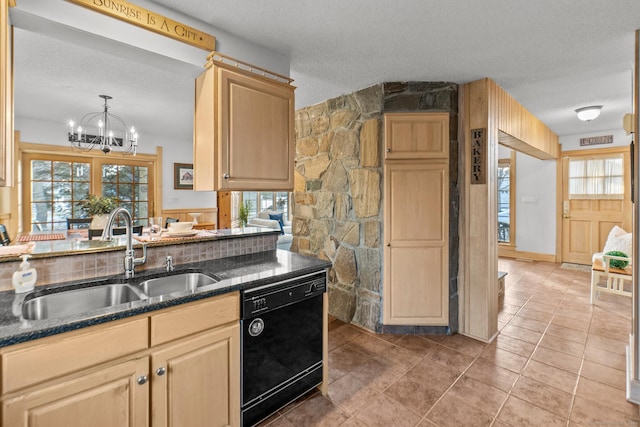 kitchen with black dishwasher, a healthy amount of sunlight, a sink, and a textured ceiling