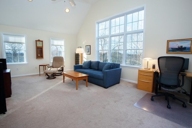 carpeted office with ceiling fan and high vaulted ceiling