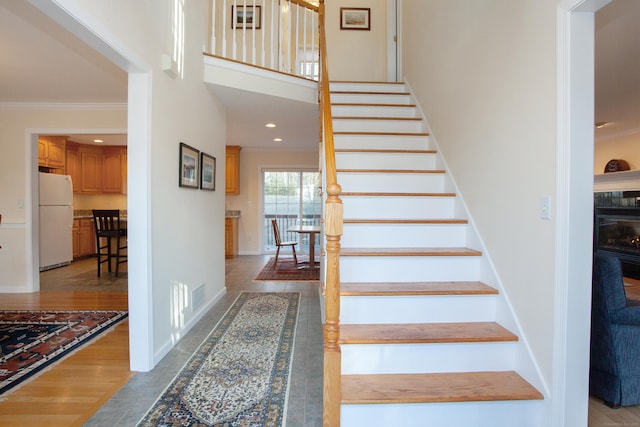 stairway featuring ornamental molding