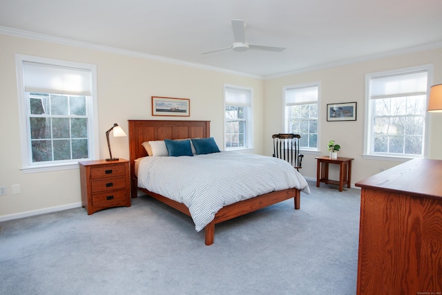 carpeted bedroom featuring ceiling fan and crown molding