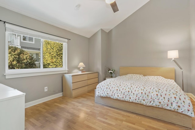 bedroom featuring ceiling fan, lofted ceiling, and light wood-type flooring