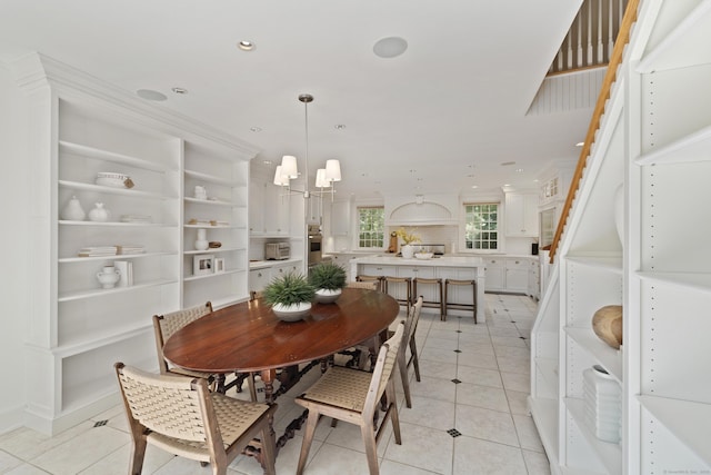 dining space with light tile patterned floors and a notable chandelier