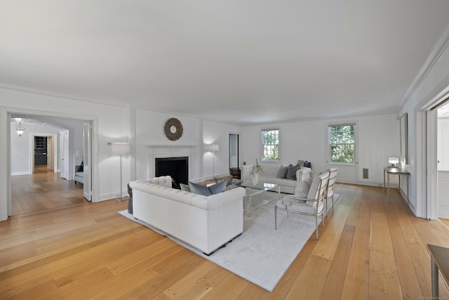 living room with ceiling fan, light hardwood / wood-style flooring, and ornamental molding