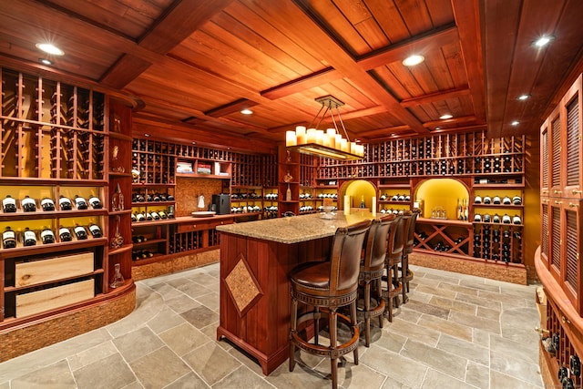 wine cellar featuring wooden ceiling and coffered ceiling