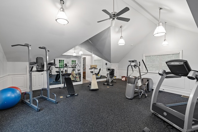 exercise room with ceiling fan and vaulted ceiling