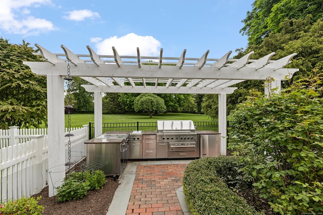 view of patio with an outdoor kitchen, grilling area, and a pergola