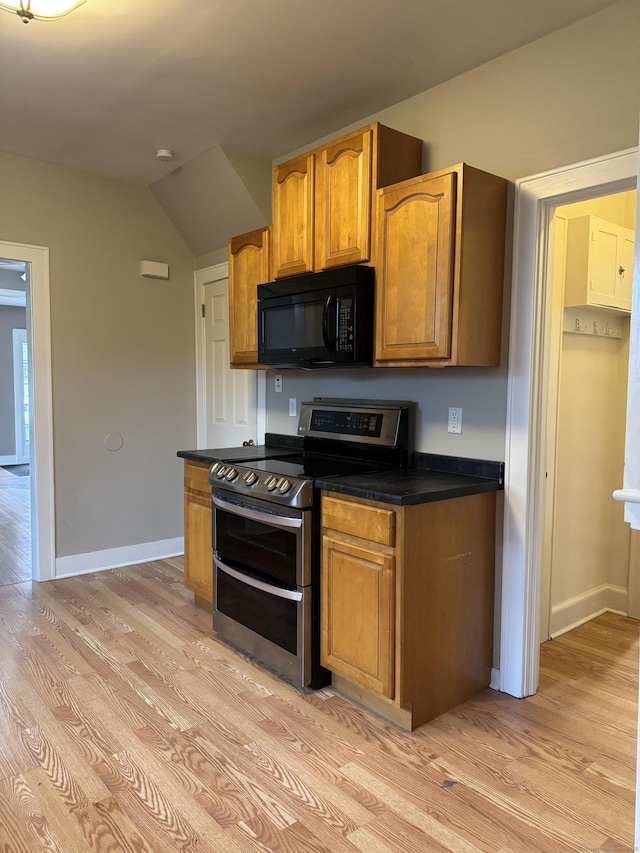 kitchen featuring double oven range and light hardwood / wood-style flooring