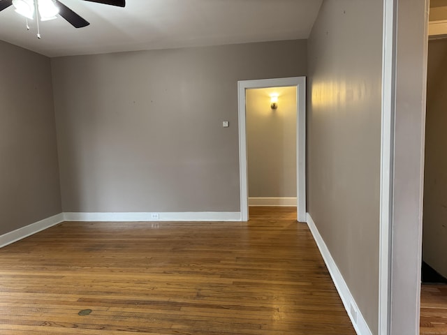 spare room with hardwood / wood-style floors and ceiling fan