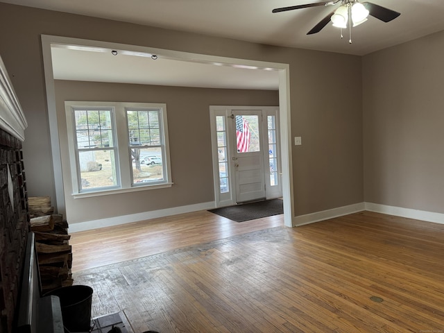 foyer entrance with light wood-type flooring, plenty of natural light, and ceiling fan