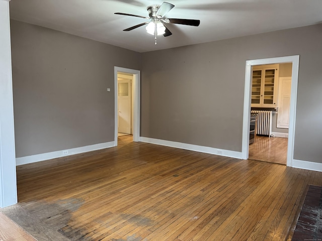 unfurnished room with ceiling fan and wood-type flooring