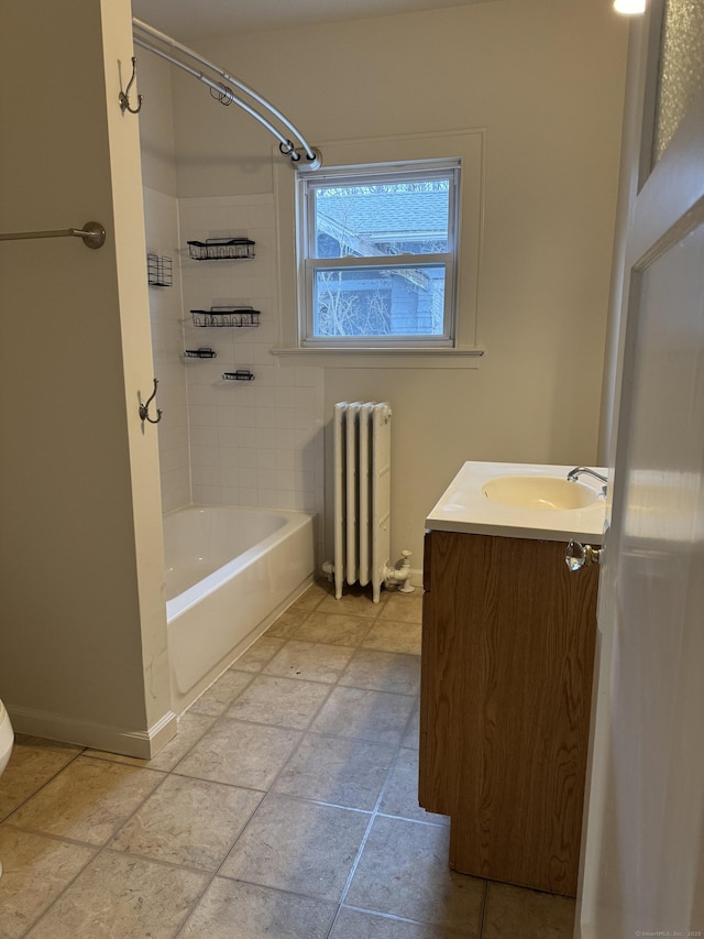 bathroom with vanity, tiled shower / bath, and radiator