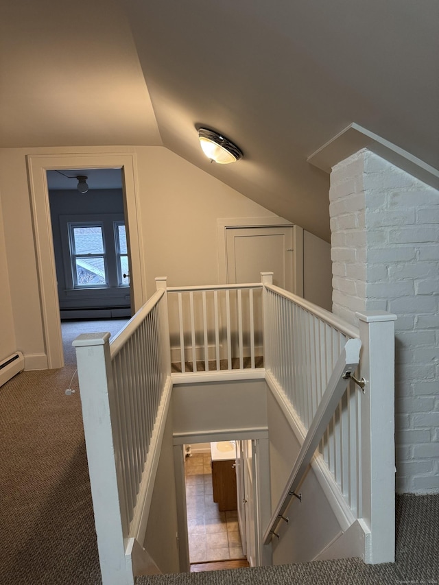 stairs with carpet, a baseboard radiator, and vaulted ceiling