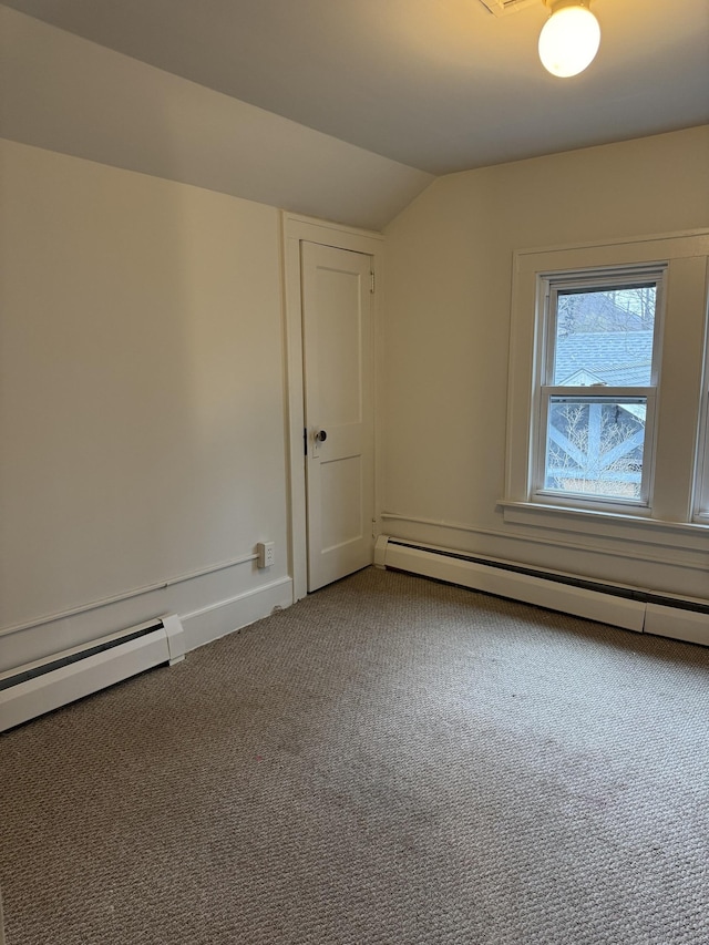 carpeted empty room featuring a baseboard radiator and lofted ceiling