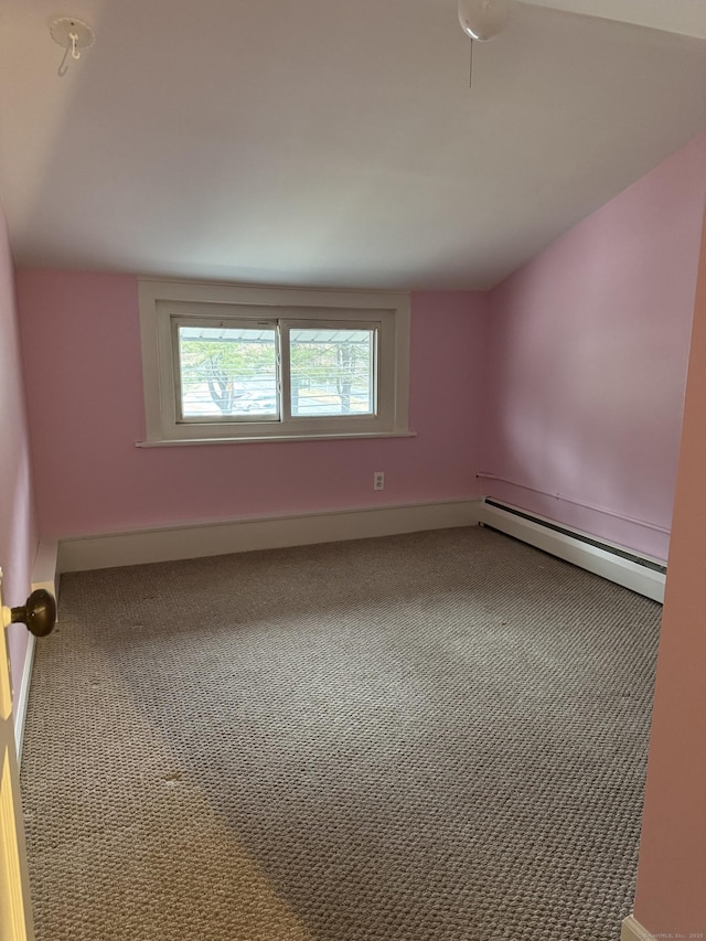 carpeted empty room with baseboard heating