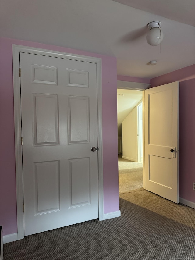 interior space with dark colored carpet