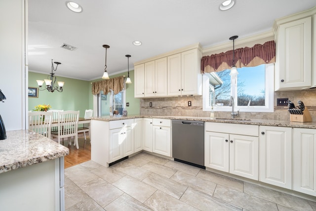 kitchen featuring kitchen peninsula, crown molding, a notable chandelier, dishwasher, and hanging light fixtures