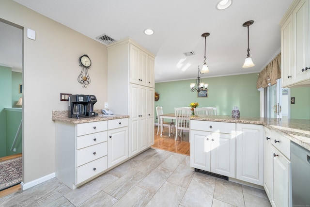 kitchen with stainless steel dishwasher, light stone counters, crown molding, an inviting chandelier, and hanging light fixtures