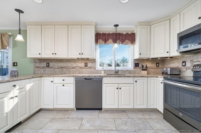 kitchen featuring pendant lighting, sink, ornamental molding, appliances with stainless steel finishes, and tasteful backsplash