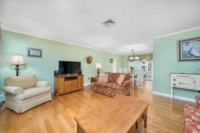 living room featuring a notable chandelier, light wood-type flooring, and ornamental molding