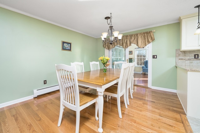 dining space featuring a baseboard radiator, an inviting chandelier, light hardwood / wood-style floors, and crown molding