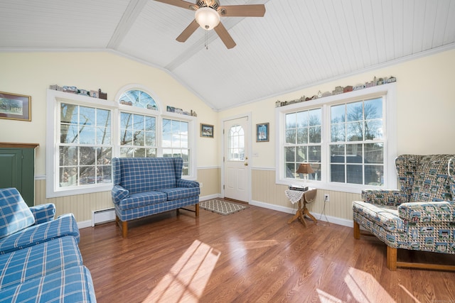 living area with lofted ceiling, wood-type flooring, baseboard heating, and ornamental molding