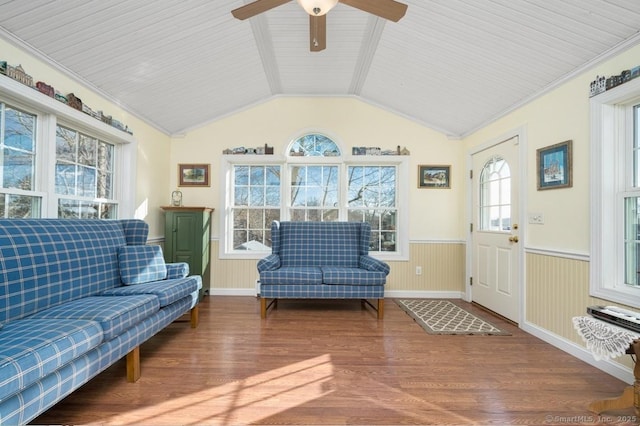 living room featuring hardwood / wood-style floors, crown molding, ceiling fan, and lofted ceiling