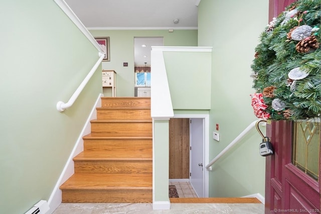 staircase featuring tile patterned floors, a baseboard radiator, and ornamental molding