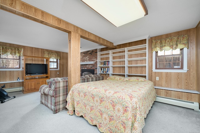 bedroom with multiple windows, wooden walls, and a baseboard radiator