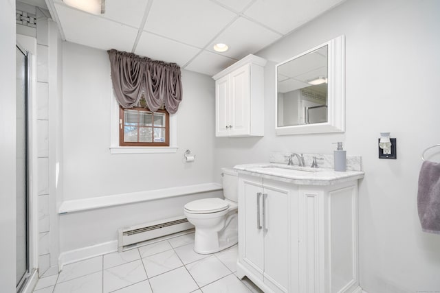 bathroom with a paneled ceiling, vanity, a shower, toilet, and a baseboard radiator