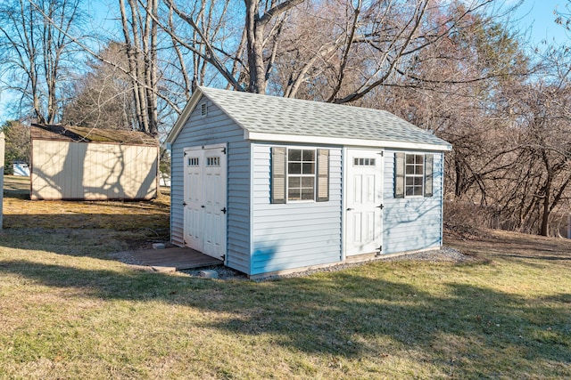 view of outbuilding with a yard