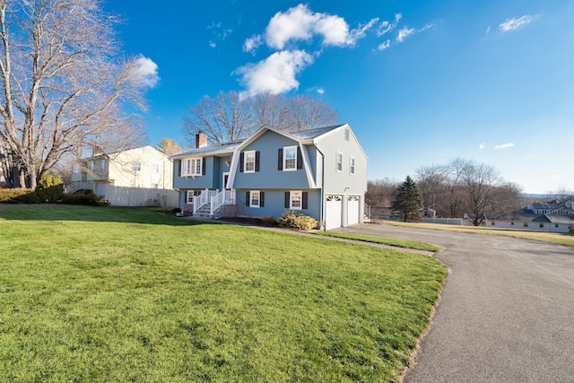 view of front facade featuring a garage and a front lawn